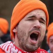 Picture of Ivo Graham wearing an orange hat and Swindon Town scarf, shouting