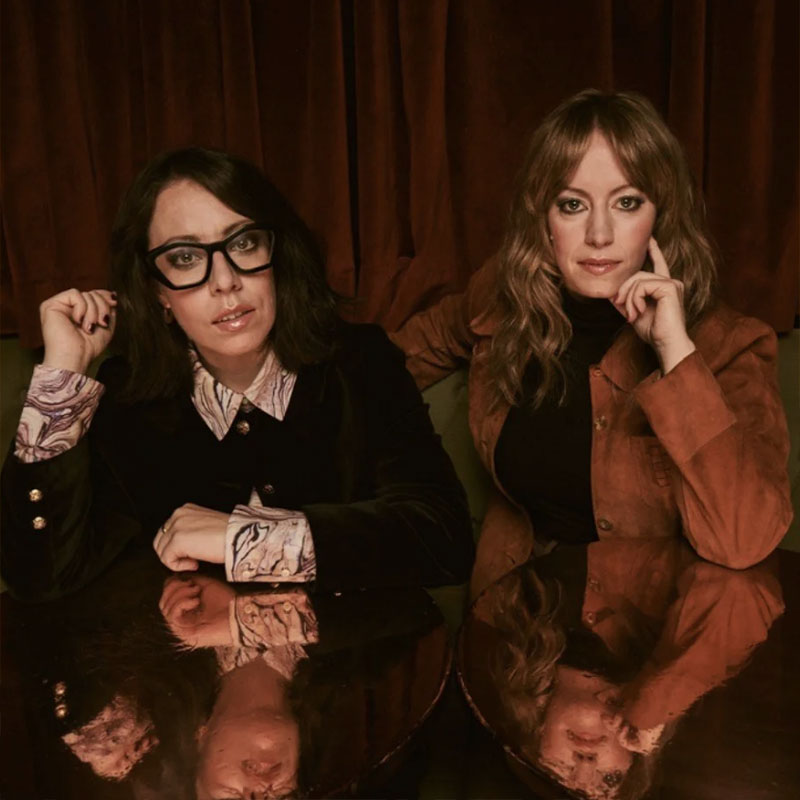 Photo of Flo & Joan sat next to each other at a table