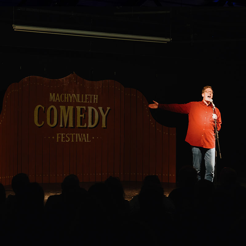 Picture of Robin Morgan hosting a previous showcase