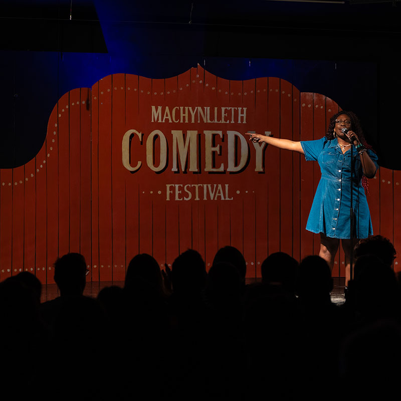 Photo of Sikisa on stage hosting a previous showcase