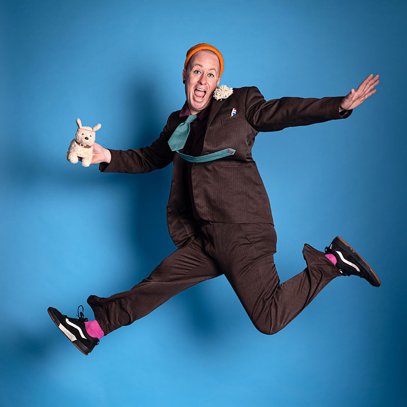 Photo of Darryl Carrington leaping in the air holding a small furry toy in one hand