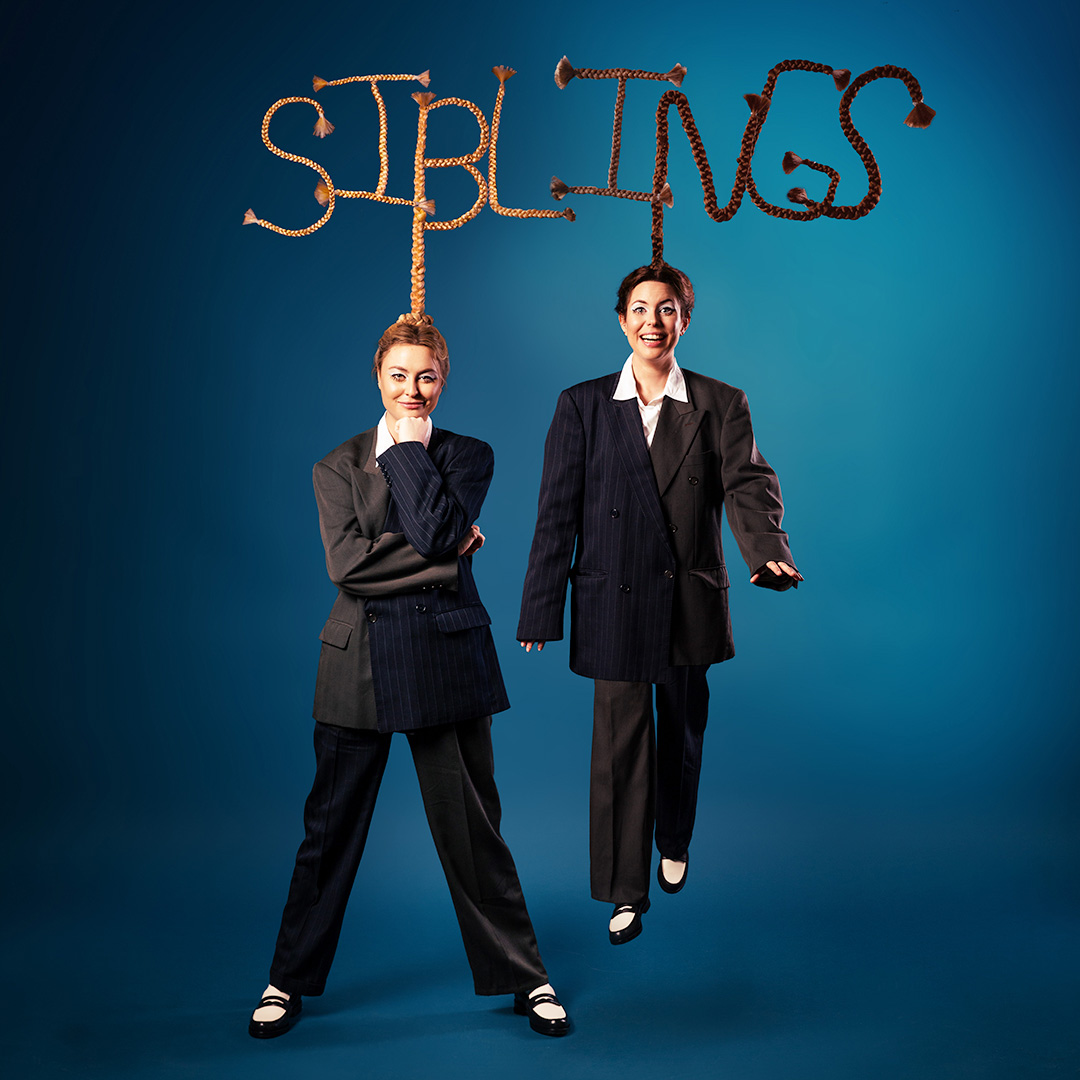 Photo of Maddy and Marina dressing in suits with Siblings logo above their heads