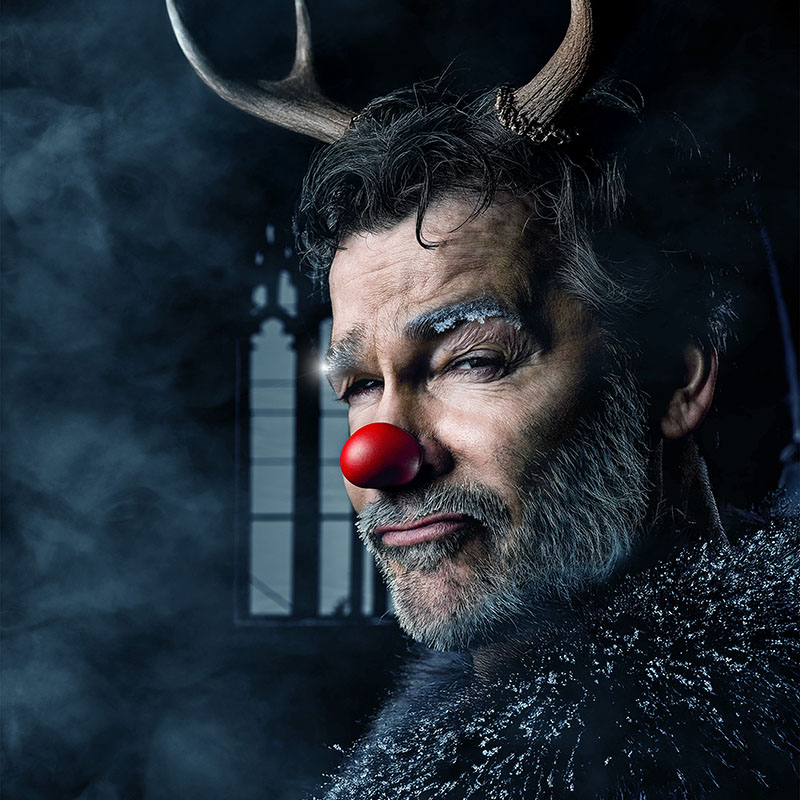 Photo of Adam Riches with Antlers and a red nose