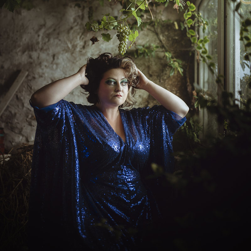 Photo of Kiri Pritchard-Mclean stood in a stone building by a window