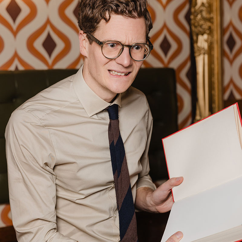Picture of Robin Morgan looking distressed with an open, empty notebook in his hands