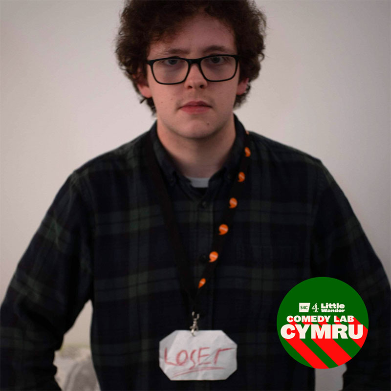 Photo of Harri Dobbs wearing a Welsh learner lanyard with 'LOSER' at the bottom of it