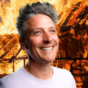 Photo of Stuart Goldsmith with a burning landscape in the background