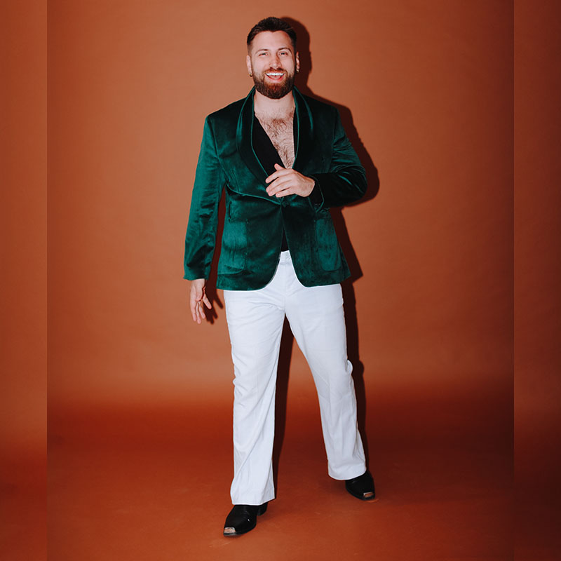 Photo of Morgan Rees in white trousers and a velvet jacket