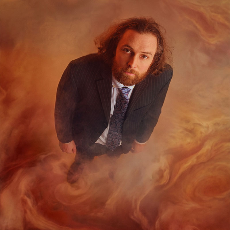 Photo of Rob Auton appearing as if he is stood on the surface of Jupiter, looking upwards