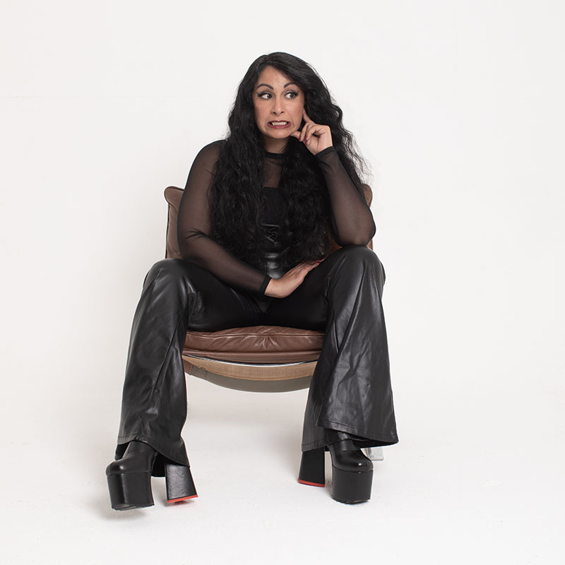 Photo of Seeta Wrightson sat on a chair against a completely white background